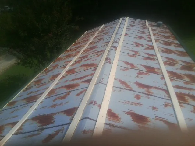 Rusted metal roof panels with new wood purlins before replacement — Storm Damage Roof Repair in Dickerson by Roofing Brothers