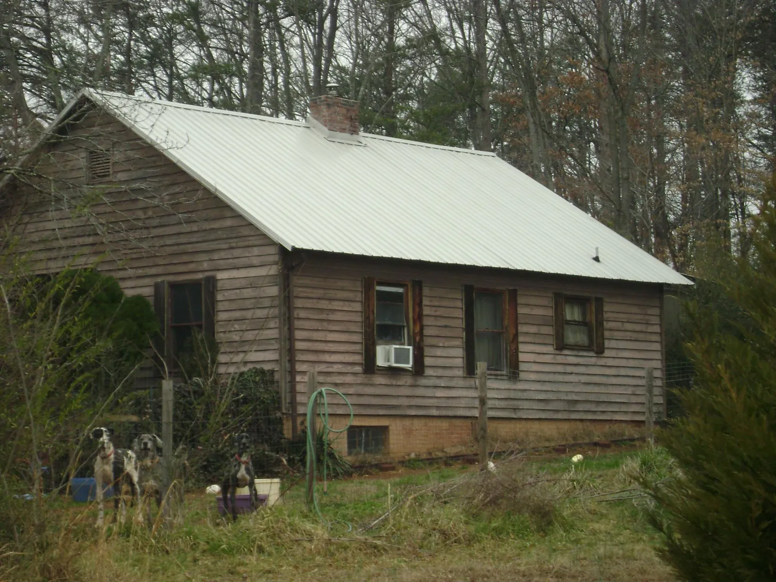 White metal roof on an old wood sided farmhouse, from a Metal Roof Installation job in Dickerson